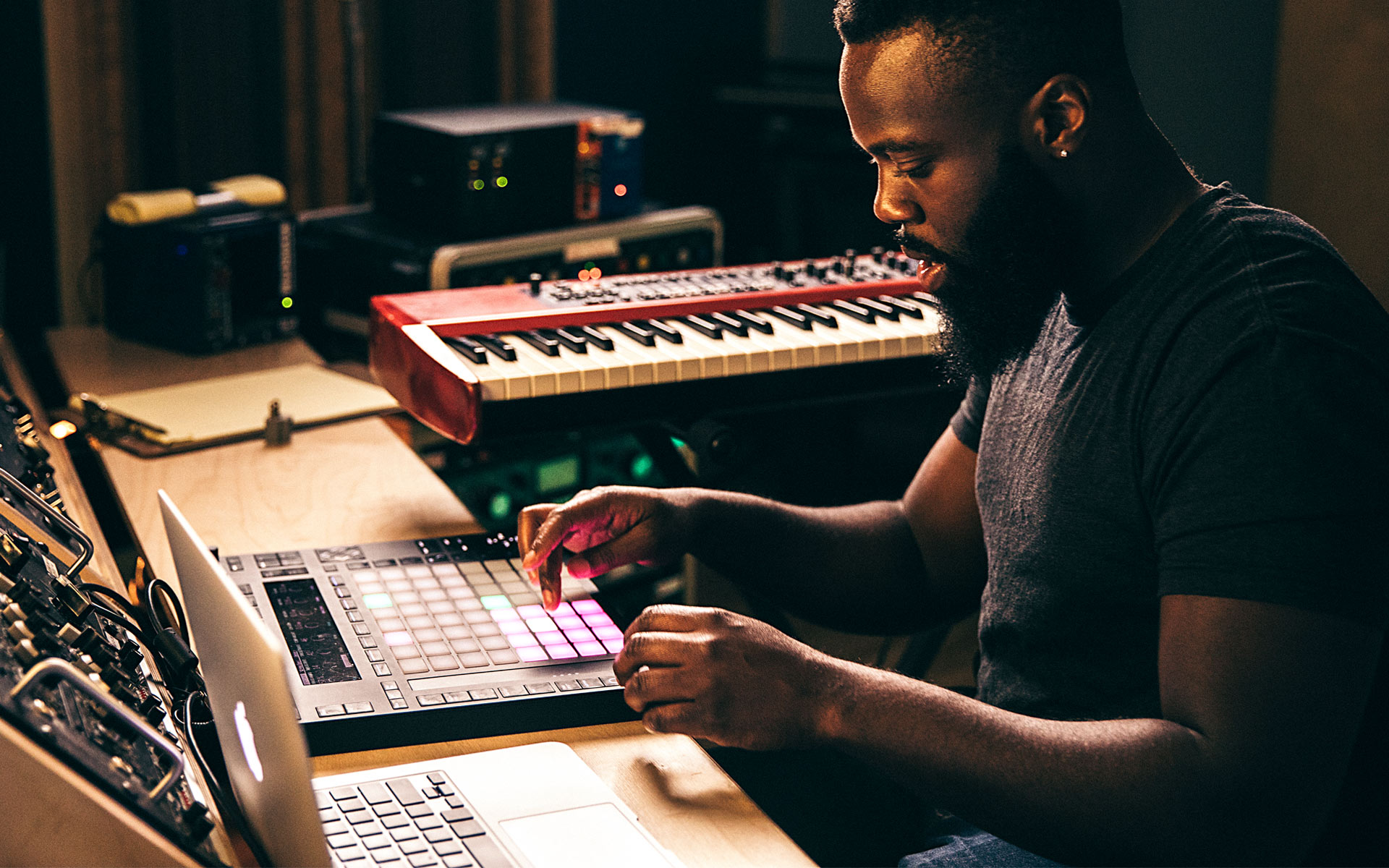 A man producing music using Ableton Live on his laptop.